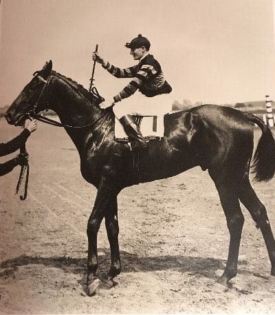Legendary thoroughbred Man o' War set a then-record for speed when he won the 1920 Belmont Stakes, shown here after the race with jockey Clarence Kummer