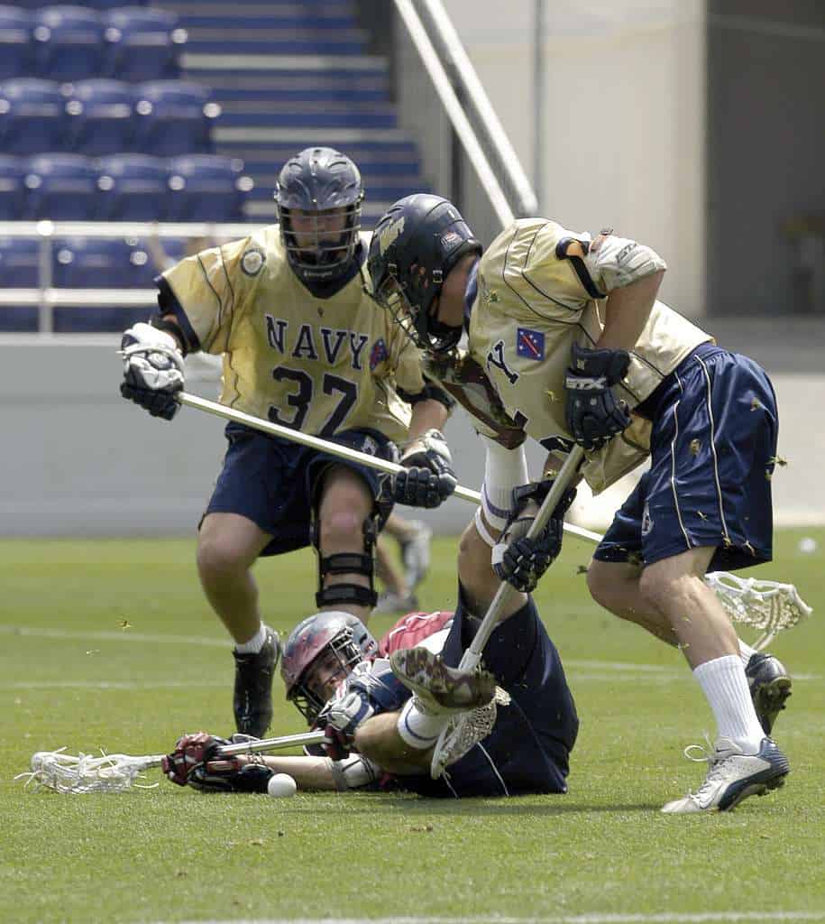 Annapolis, Md. (May. 17, 2004) University of Pennsylvania's P.J. Gilbert tries to fend off Midshipman 2nd Class Dan Harris, right, as Midshipman 1st Class Jared Bosanko comes in to assist during the first round action of the NCAA Lacrosse tournament. This is the first time since 1989 that the Navy (13-2), ranked number 2 in the nation, will advance to the second round of the Div. I NCAA Lacrosse Tournament, following an opening-round 11-5 victory over 13th-ranked Penn (7-7) Sunday at Navy-Marine Corps Memorial Stadium.