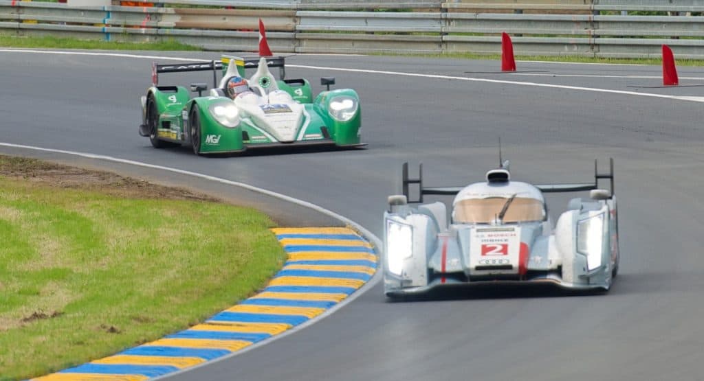 Audi Sport Team Joest's R18 e-tron quattro (car number 2) leads Greaves Motorsport's Zytek Z11SN (car number 41) through a corner at the 2013 24 Hours of Le Mans