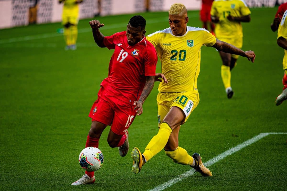 #19 Alberto Quintero for Panama and #20 Matthew Briggs for Guyana jockey for the ball at the 2019 Gold Cup