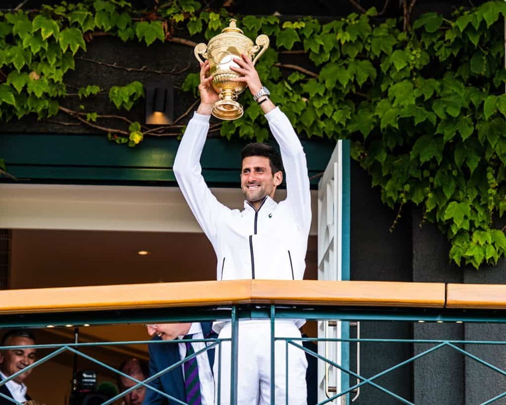 Novak Djokovic hoists the Wimbledon trophy after his 2019 Gentlemen's Singles victory