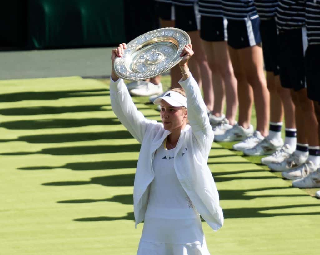 Elena Rybakina raises the Venus Rosewater Dish after winning the Ladies' Singles Championship at Wimbledon in 2022.