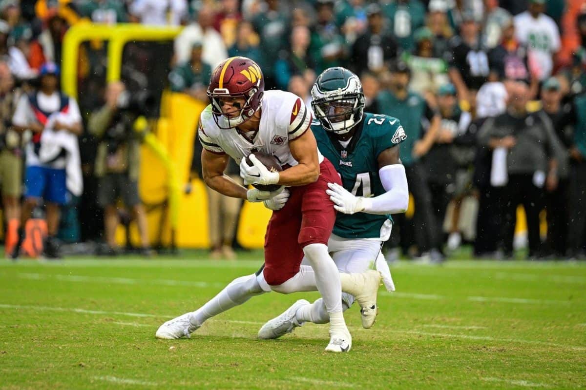 Philadelphia Eagles cornerback James Bradberry tackles Washington Commanders wide receiver Dax Milne