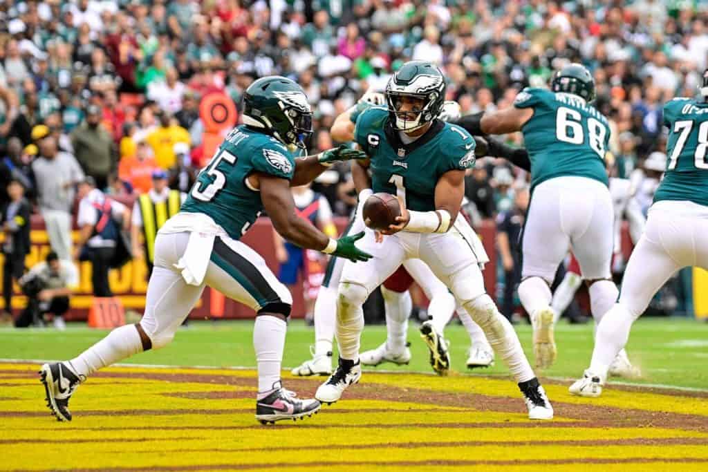 Philadelphia Eagles quarterback Jalen Hurts passes the ball to running back Boston Scott - NFL Week 3: Eagles @ Washington Commanders, September 25, 2022
