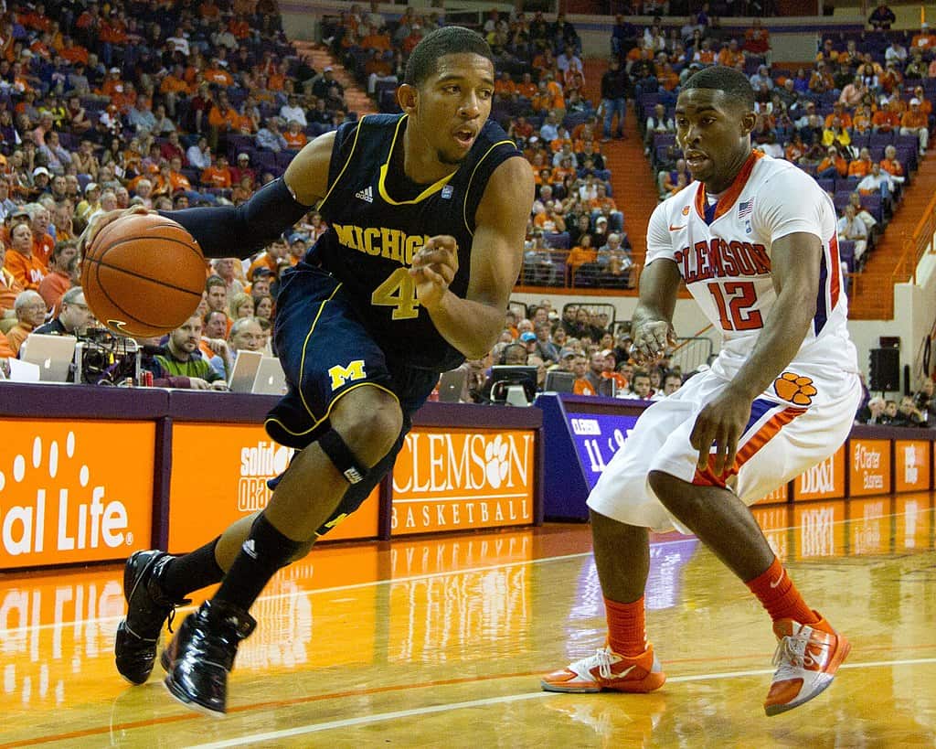 Darius Morris (Michigan) drives on Cory Stanton (Clemson) - NCAA Basketball