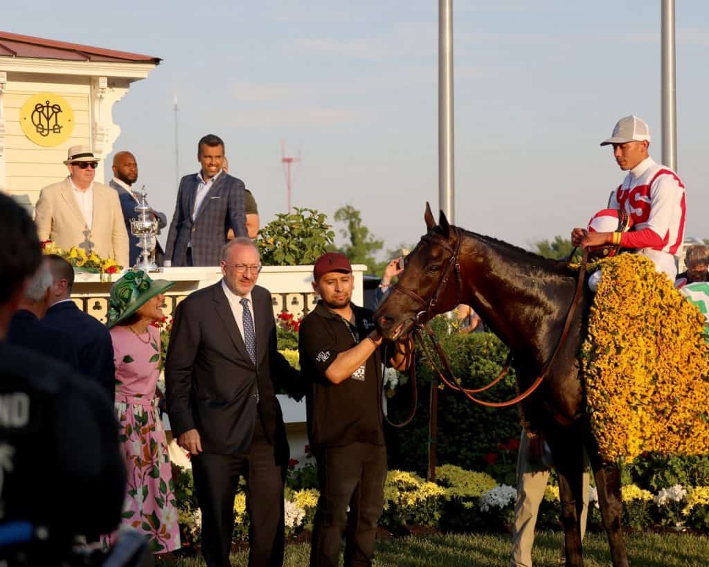 Early Voting, ridden by Jose Ortiz and trained by Chad Brown, in the 2022 Preakness winner circle with his Black-Eyed Susan blanket.