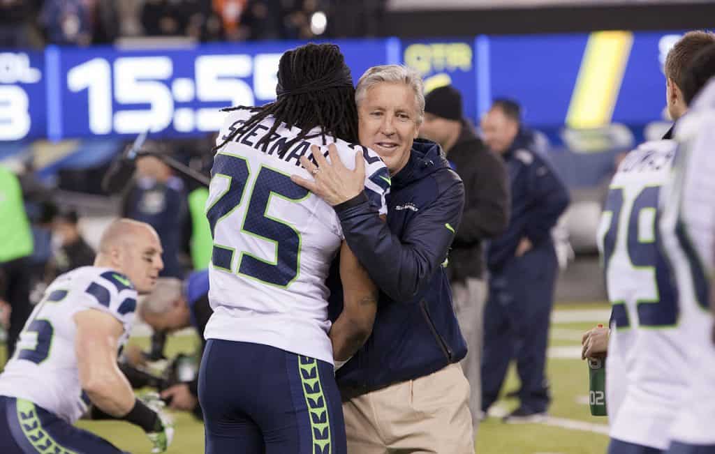Cornerback Richard Sherman and Head Coach Pete Carroll of the Seattle Seahawks hugging During Super Bowl XLVIII